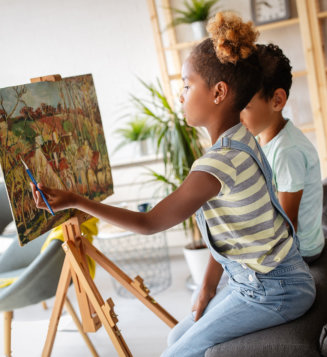 girl and boy painting together