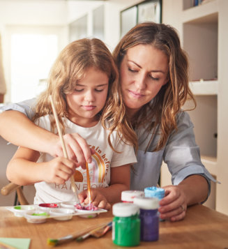 woman teaching her daughter to paint