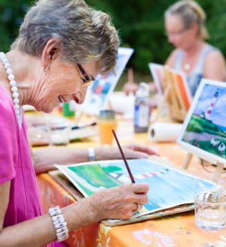 woman smiling while drawing with the group