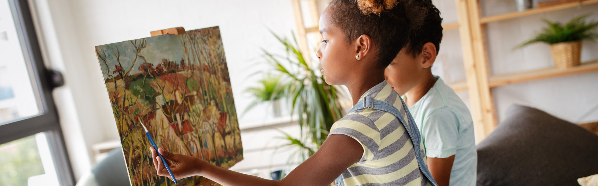 girl and boy painting together