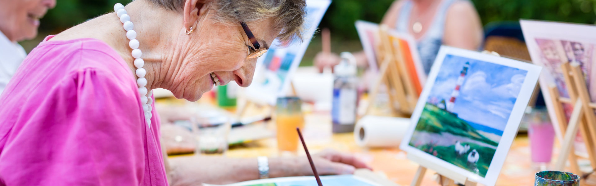 woman smiling while drawing with the group